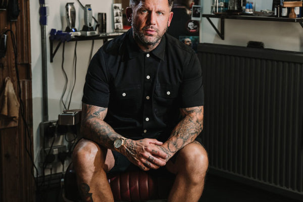 a model portfolio of a tattooed barber